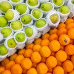pile of green apples and orange fruits
